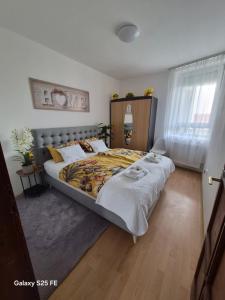a bedroom with a large bed in a room at Zafir Luxory in Kaposvár