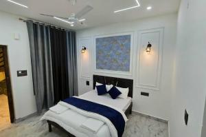 a bedroom with a bed with blue pillows and a window at Velley inn hotel & resort in Barkot