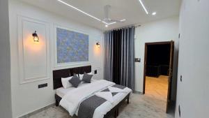a bedroom with a bed and a painting on the wall at Velley inn hotel & resort in Barkot