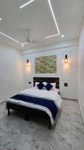 a bedroom with a large bed with blue pillows at Velley inn hotel & resort in Barkot