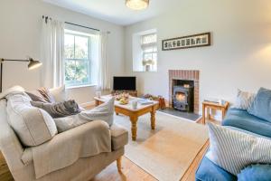 a living room with a couch and a table at 4 Bed in St. Mawgan oc-p00610 in Saint Mawgan