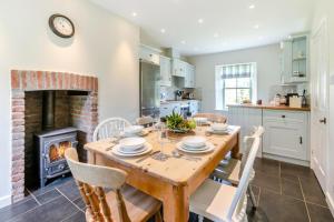 a kitchen and dining room with a table and a fireplace at 4 Bed in St. Mawgan oc-p00610 in Saint Mawgan