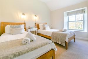 a bedroom with two beds and a window at 4 Bed in St. Mawgan oc-p00610 in Saint Mawgan