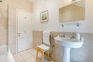 a white bathroom with a sink and a shower at 4 Bed in St. Mawgan oc-p00610 in Saint Mawgan +18 photos