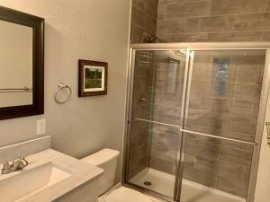 a bathroom with a shower and a toilet and a sink at Valhalla Resort Hotel in Helen