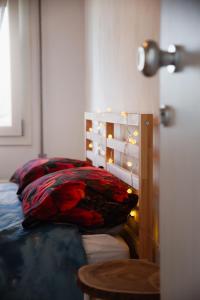 a bedroom with a bed with red pillows on it at Ca' Foega rooms in Chioggia
