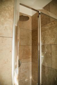 a shower with a glass door in a bathroom at Ca' Foega rooms in Chioggia +14 photos