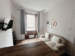a living room with a couch and a table at Edinburgh Cozy Apartment in Edinburgh