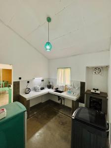 a kitchen with a white counter in a room at Casa Meraki in Dickwella +2 photos