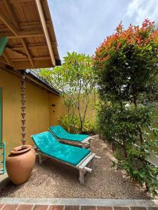two chaise lounges on the patio of a house at Casa Meraki in Dickwella