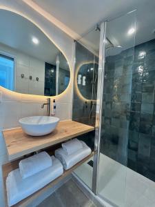 a bathroom with a sink and a shower at Hôtel Le Clos du Dramont in Saint-Raphaël +126 photos