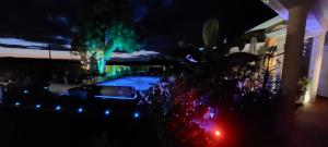 a view of a swimming pool at night with lights at La Clef Des Anges 2 Chambres in Égliseneuve-près-Billom +42 photos