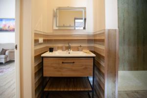 a bathroom with a sink and a mirror at By Tau in Almaty +152 photos
