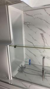 a freezer door of a refrigerator with a glass shelf at PLUS Properties Oxford 1 in Stoke on Trent