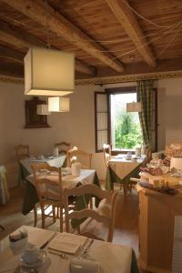 a dining room with tables and chairs and a window at B&B Gastaldo di Rolle in Cison di Valmarino