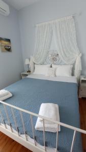 a bedroom with a large bed with a white canopy at Galini in Mytikas