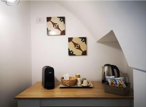 a kitchen counter with a table with a coffee maker at Suite Le Cementine in Mottola