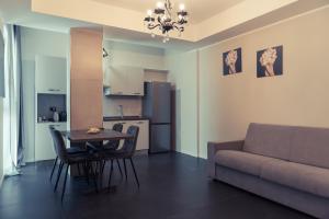a living room with a table and a couch at Palazzo Digiuseppe Rooms in Martina Franca +40 photos