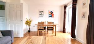 a living room with a wooden table and chairs at Spacious 4 Bedroom House, Old Town in Swindon +8 photos