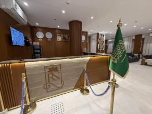 a lobby with a bar with a flag on it at Retaj Al Noor Hotel, فندق ريتاج النور in Medina