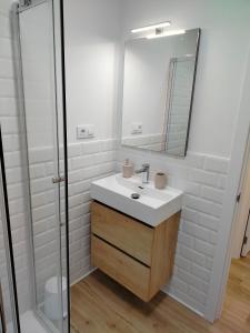a bathroom with a sink and a shower at El Pinar Beach in Comillas +17 photos