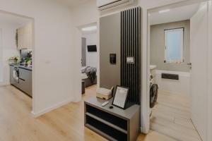 a living room with a table and a room with a kitchen at Lumea Noir - Designer Apartment in Timișoara in Timişoara