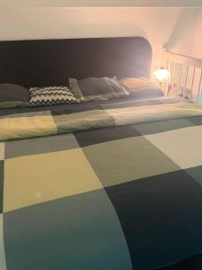 a bedroom with a bed with a checkered floor at Urban Pair Luxe Suites in Vantaa