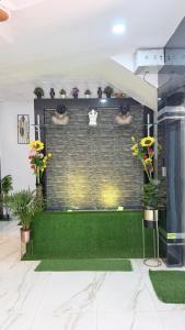 a living room with a brick wall with plants at rajapalace in Zahirābād