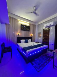 a bedroom with a bed with purple lights in it at Gully Ghar in Varanasi +161 photos
