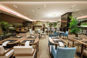 a restaurant with wooden tables and chairs at The Westin Panama in Panama City