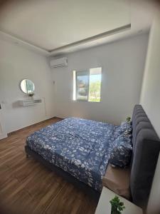 a bedroom with a bed and a couch in it at Villa Maya House - Cap Zbib in Banī ‘Aţāʼ +18 photos