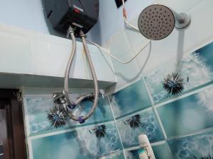 a hair dryer and a hair clipper hanging on a wall at The Fortune Mango in Jajpur Road