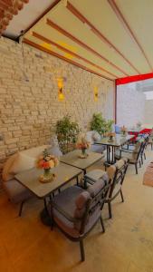 a room with tables and chairs and a brick wall at Abelia Mansion Hotel in Istanbul