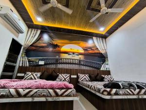 a room with two beds and a painting on the wall at Hotel Manasvi in Khātu