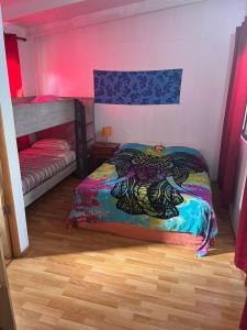 a bedroom with a bed and a bunk bed at Hostal y Cabañas Pua Vaenga in Hanga Roa