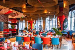 a dining room with tables and chairs in a restaurant at Hotel Wins Apec Phú Yên in Tuy Hoa