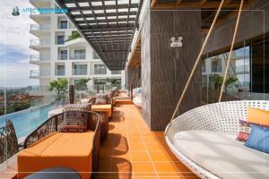 a balcony with swings and a pool on a building at Hotel Wins Apec Phú Yên in Tuy Hoa