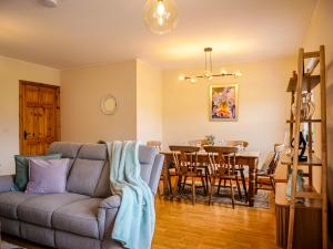 a living room with a couch and a table at Central Dingle Stay in Dingle