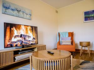 a living room with a fireplace and a tv at Central Dingle Stay in Dingle