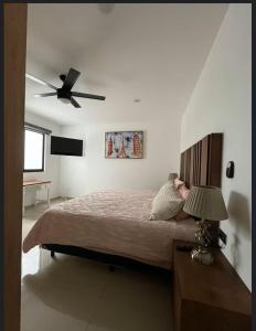 a bedroom with a bed with a ceiling fan at Complejo Las Flores in Durango