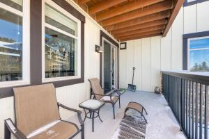 a porch with chairs and windows on a building at Fraser Crossing 3302 in Winter Park