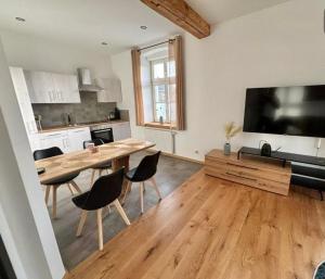 a living room with a wooden table and a kitchen at Casa Roberto, Apartment 1 in Mariazell