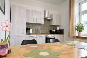 a kitchen with a wooden table with chairs and a dining room at Casa Roberto, Apartment 1 in Mariazell