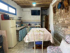a kitchen with a table and a refrigerator at Casa Pili in San Vito +33 photos
