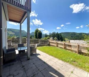 a gazebo with a bench and a fence at Casa Roberto, Apartment 1 in Mariazell