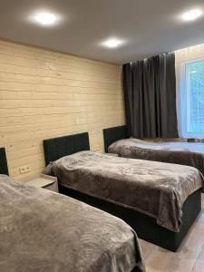 a hotel room with two beds and a window at Bellissimo Garden Villa in Tsaghkadzor +88 photos