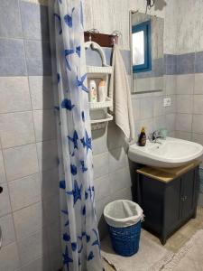 a bathroom with a sink and a shower curtain at Casa Pili in San Vito