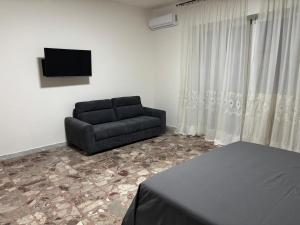 a living room with a couch and a television at Dayana House in Gallipoli