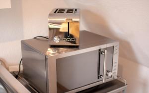 a coffee maker sitting on top of a microwave at Luv Lee Duhnen 09 in Cuxhaven +2 photos