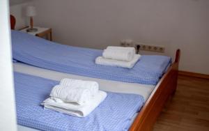 two twin beds with towels on top of them at Luv Lee Duhnen 09 in Cuxhaven